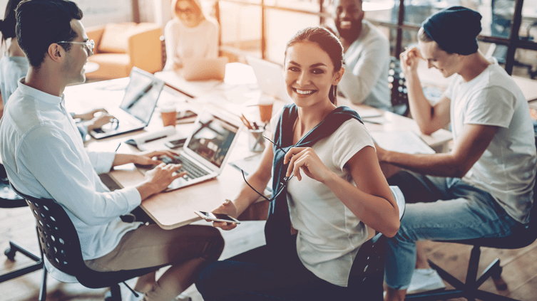 Team meeting with female smiling at camera