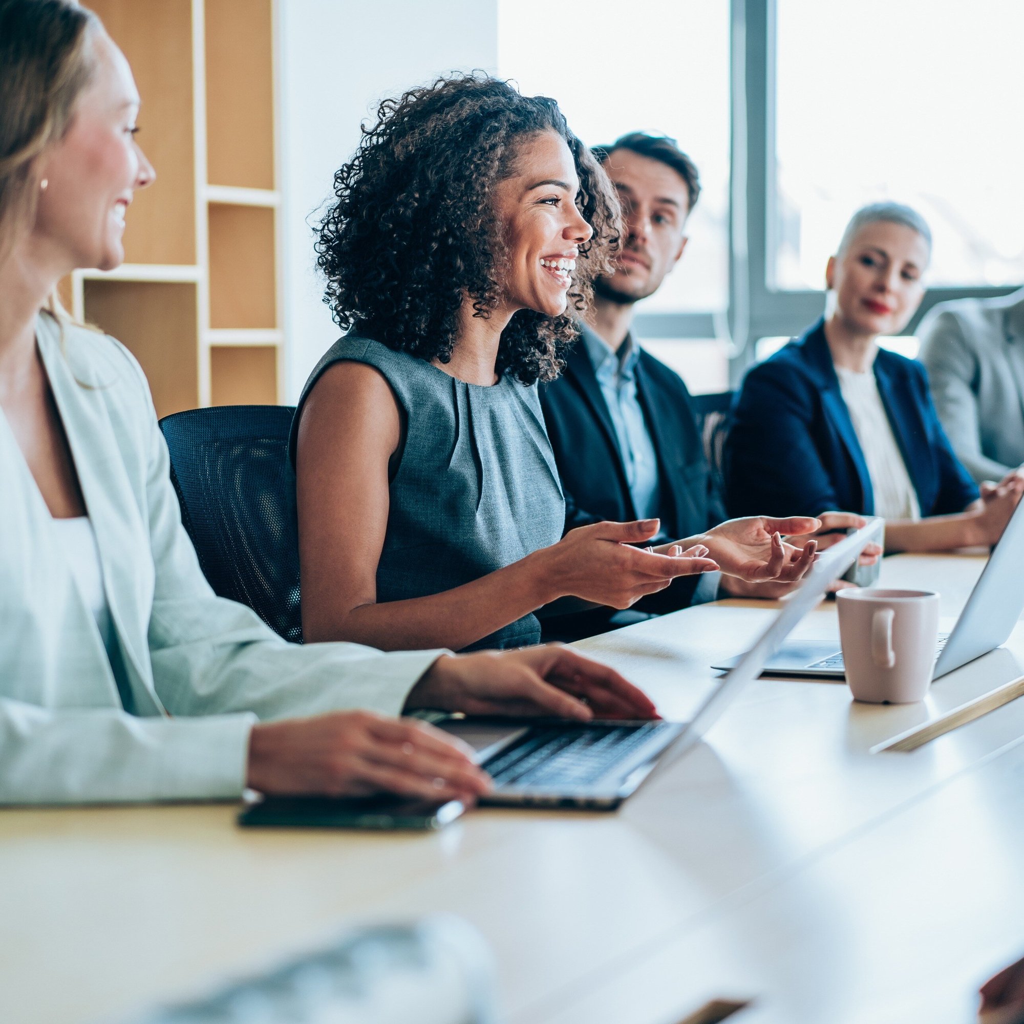group of office people in meeting_office_laptop_iStock-1366137792