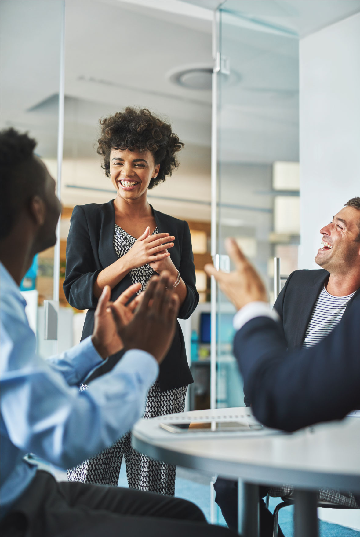 people clapping in team meeting