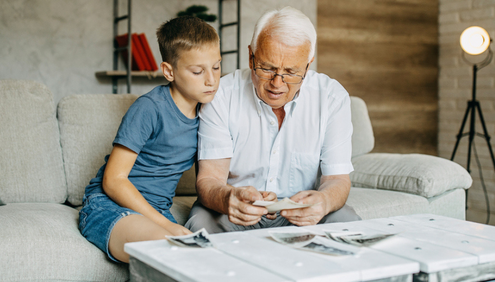 grandfather looking at photos with grandson