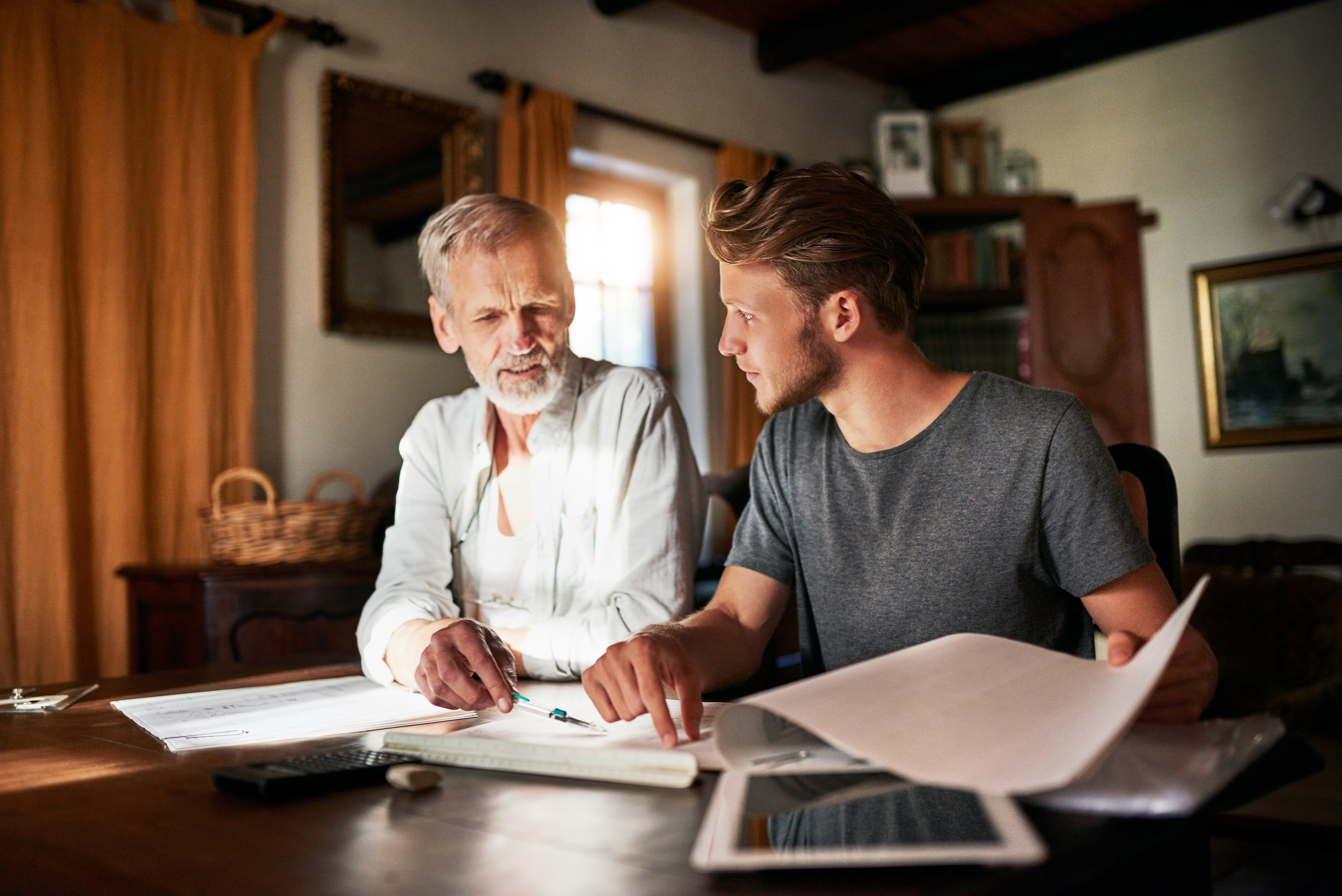 father and son_working and discussing at home_iStock-1095307916