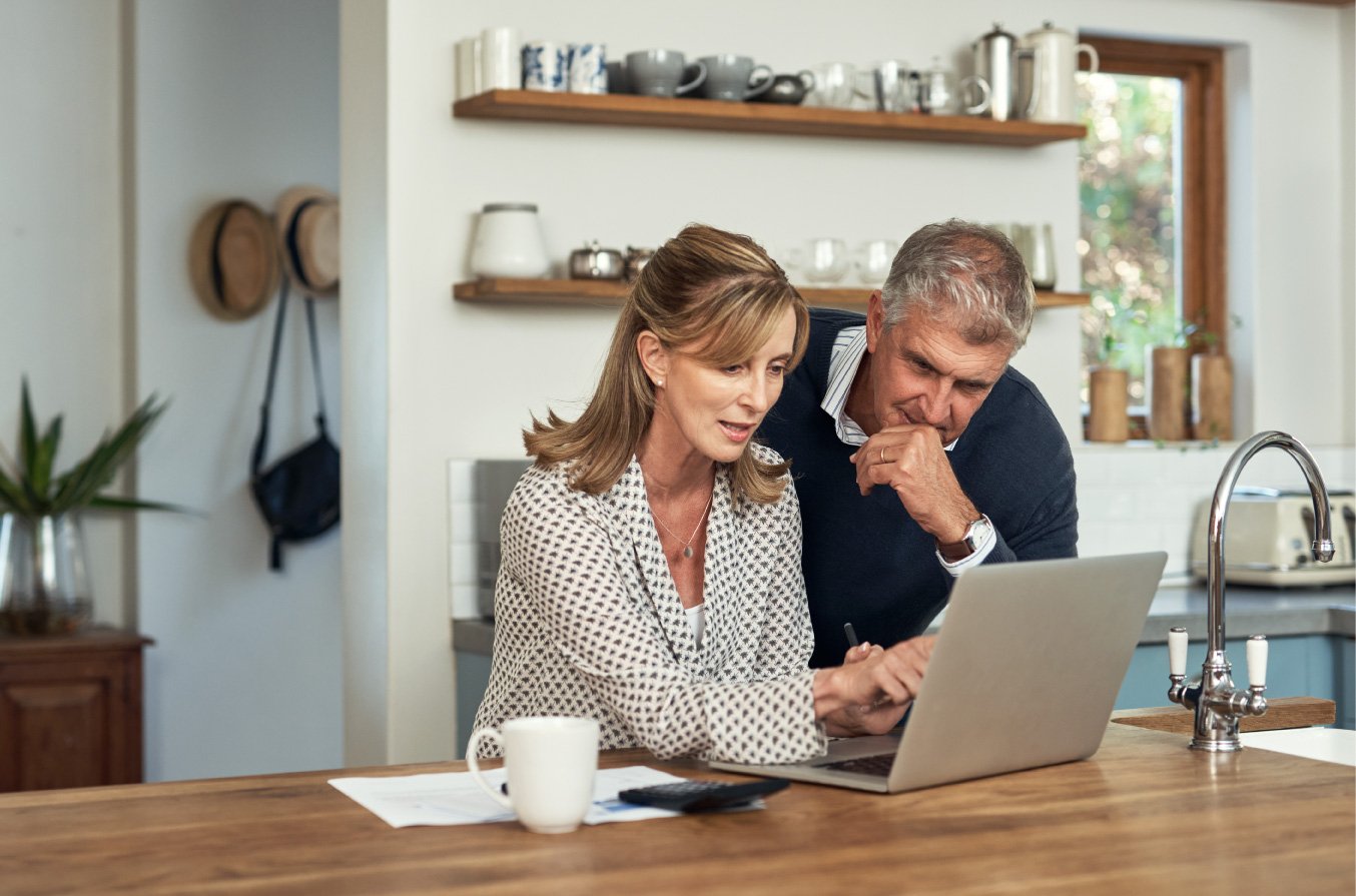 iStock-1399376478---A-senior-couple-planning-their-finance-and-paying-bills-while-using-a-laptop-at-home.---resized