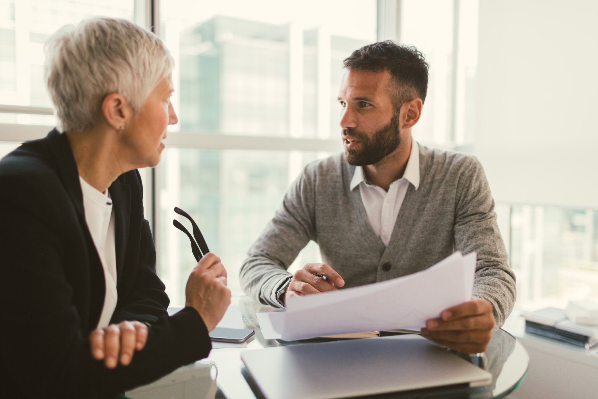 iStock-669488282_Business-people-on-meeting-in-the-office.-Sitting-and-talking-with-documents-in-their-hands_resized