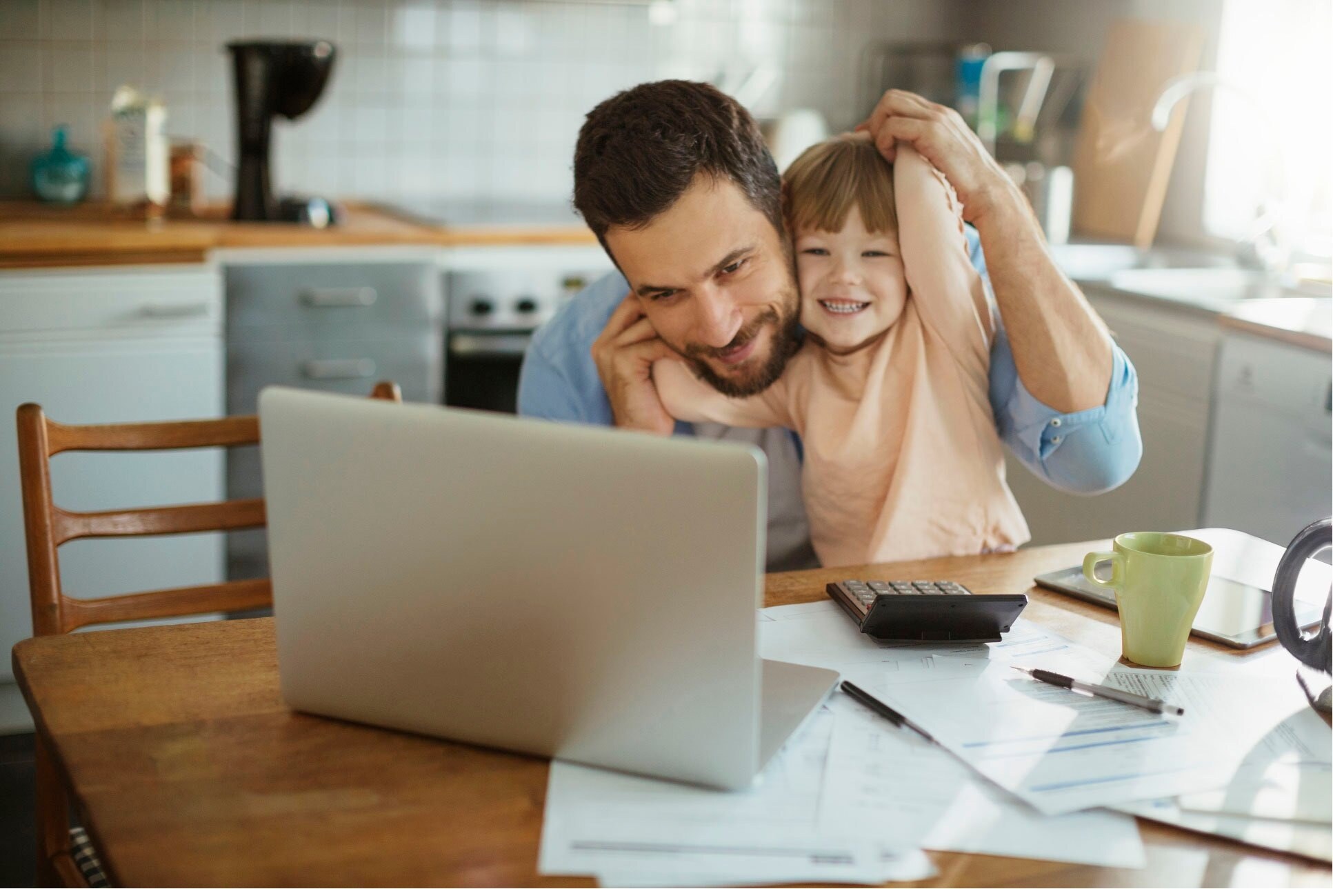 man with his child and a laptop