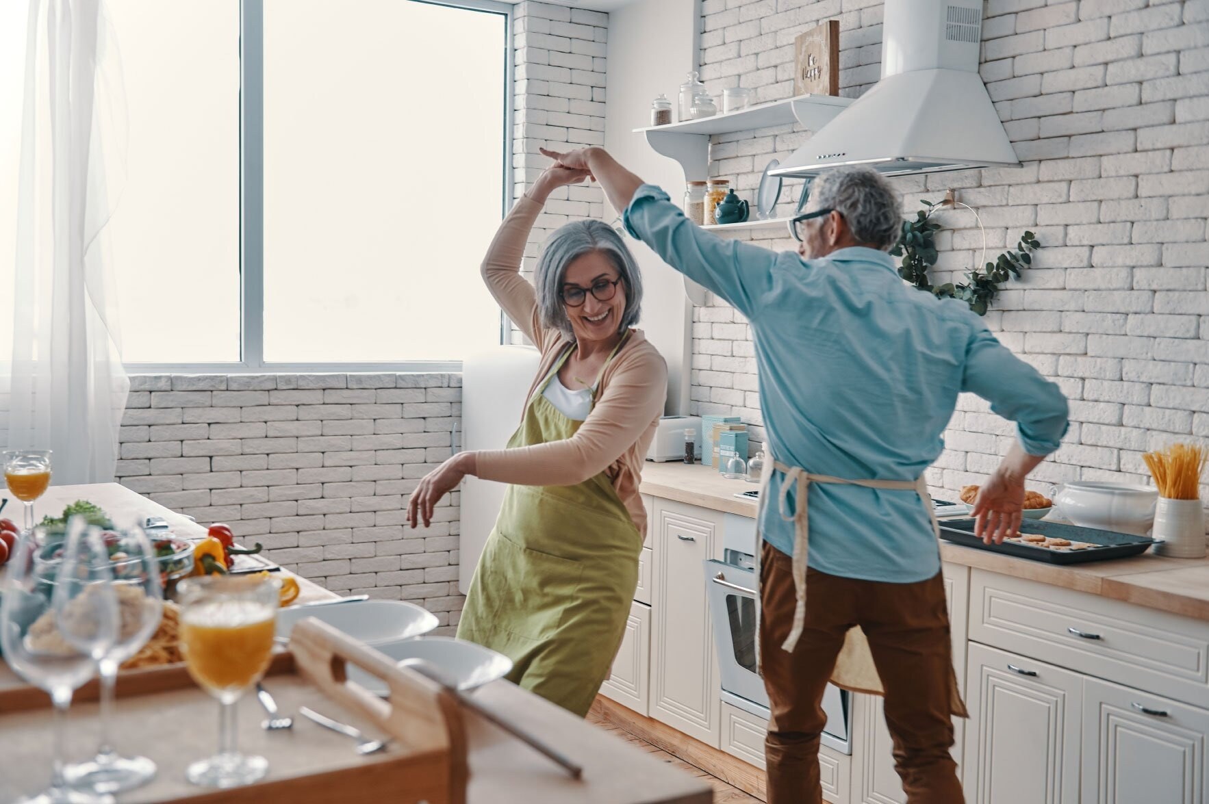 older-couple-dancing-in-the-kitc