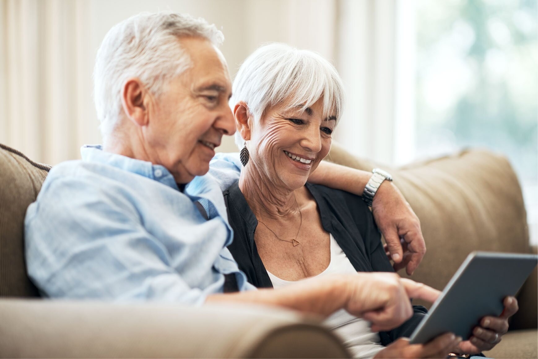 older-couple-sitting-on-couch-wi